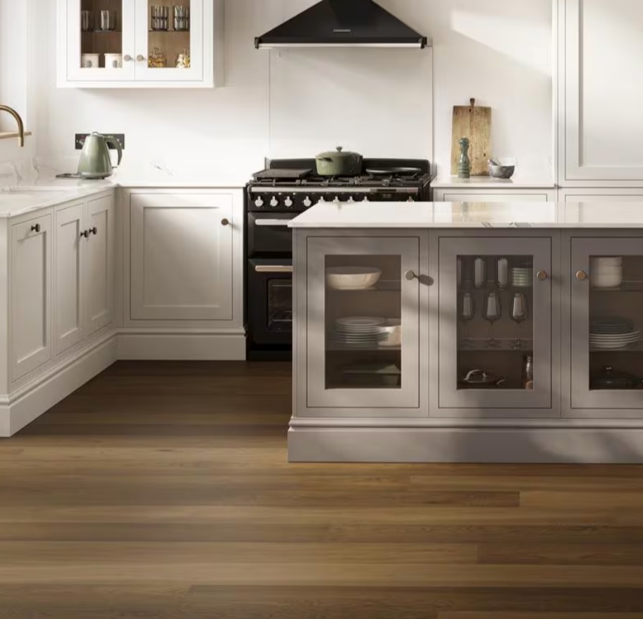 Warm wood flooring in a fitted kitchen with island